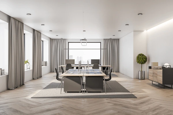 Best Measured Curtains in Dubai 2025 showcasing light grey measured drapes in a minimalist open-space office with modern furniture and wooden flooring for a sleek professional look.