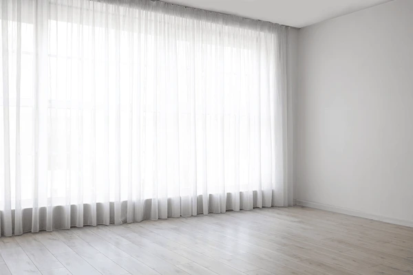 Bright modern interior with sheer white curtains covering large windows in Dubai 2025.