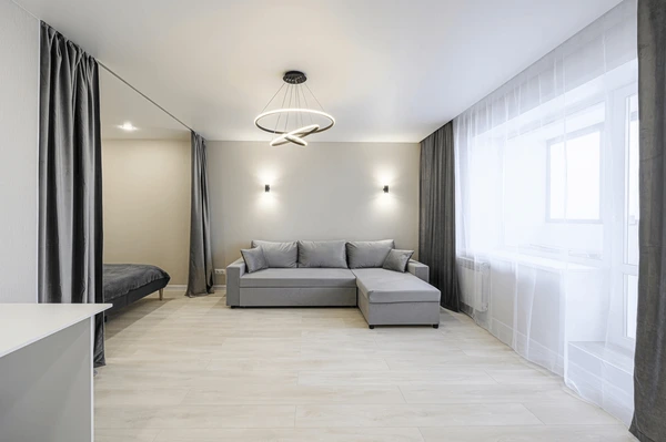 Modern Dubai apartment interior featuring stylish gray bedroom curtains, elegant sofa, and minimalist lighting in 2025.