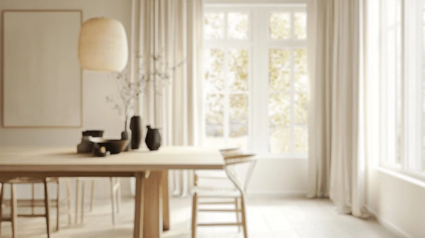 Bright and airy dining area in Dubai with beige linen curtains, wooden furniture, and soft natural light — showcasing the top trending curtain style for November 2025.