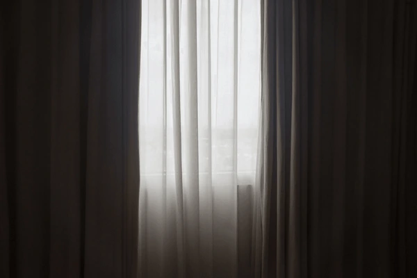 Elegant light grey sheer curtains filtering soft daylight in a Dubai home, showcasing a minimalist and modern interior design perfect for November 2025 trends.