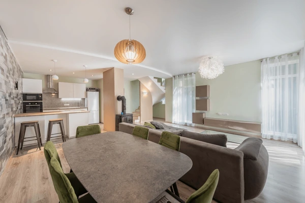 Modern open-plan living and dining area in Dubai featuring sheer white curtains, neutral walls, and contemporary furniture — showcasing top trending curtain designs for November 2025.